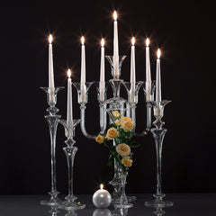 White candles on glass candelabra and candleholders on a black background. The Carmen collection designed by Gabriela Seres and handmade in Bucharest, Romania atelier.