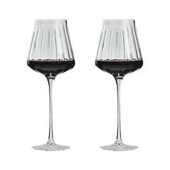 Two wine glasses filled with red wine on a white background