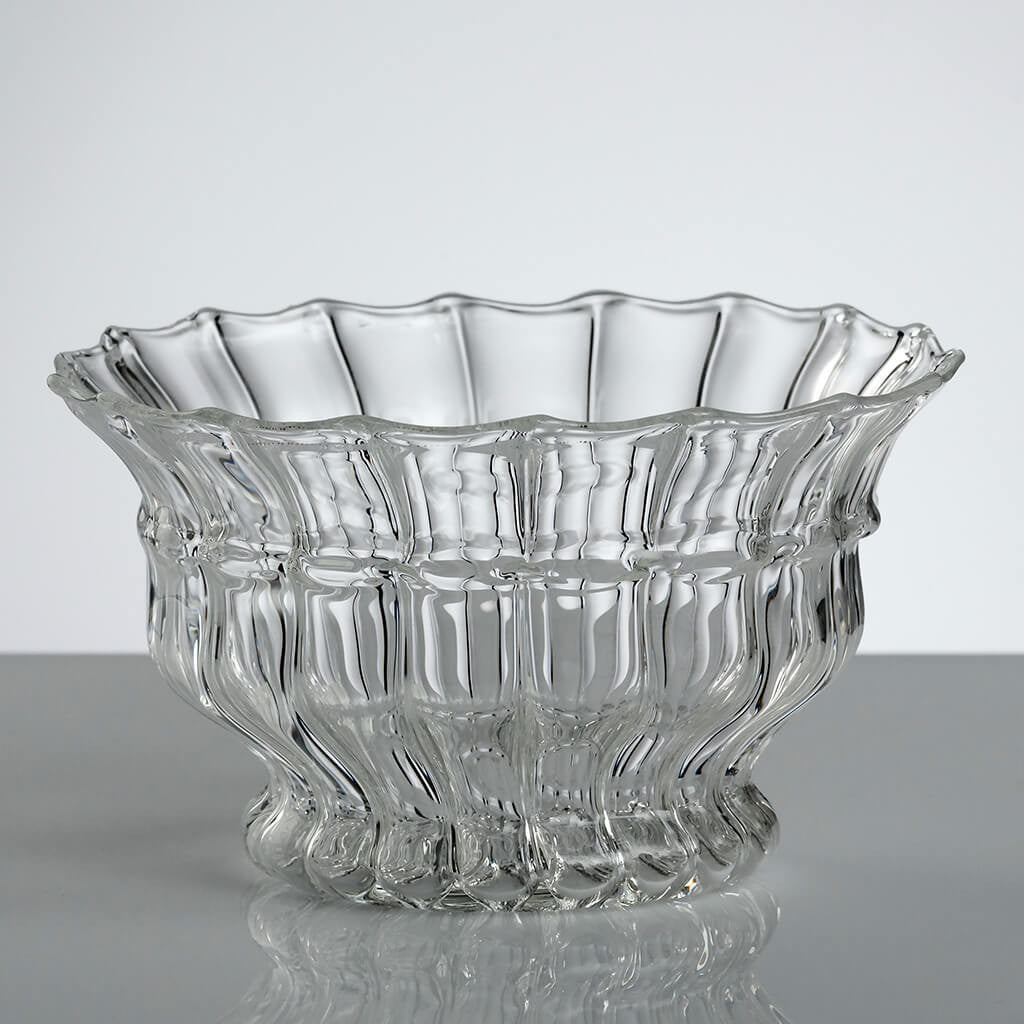 Glass bowl handmade from lined glass on a grey table and background. Handmade in the Gabriela Seres Atelier